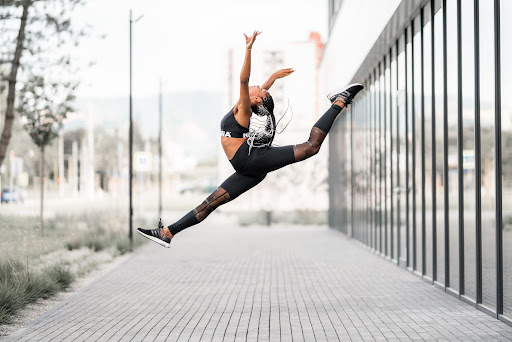 a woman performing outdoor yoga wearing gym and yoga leggings